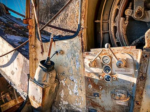 Driver's cab of an old, decayed excavator from an earlier time Stock Photos