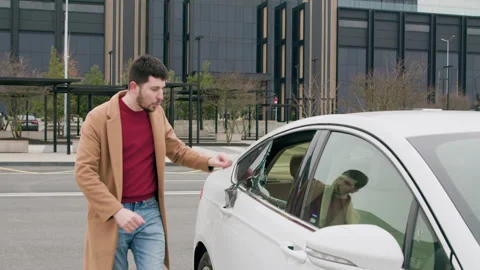 Driver's display intense anger emotion as he look at broken glass of car. With Vidéo 269707141