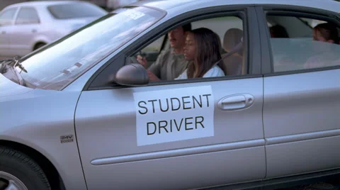 Driver's ed students and instructor beginning a behind-the-wheel lesson Video stock 59533574