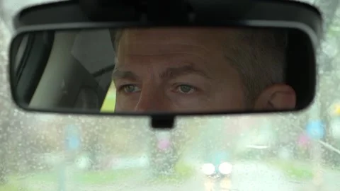 The driver's eyes in the car mirror Stock Footage 163860959