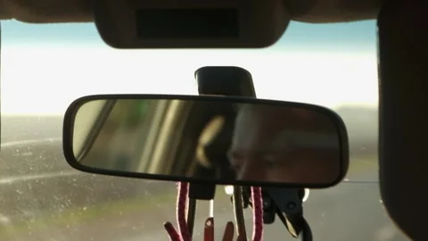 The driver's face in the rearview mirror in the car Stock Footage 171897665