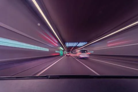Drivers front view, driving fast in a tunnel by var with lots of blurry lights Stock Photos