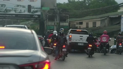 Drivers get ready as signal light turns green at rush hour in the Philippines Stock Footage 201306298