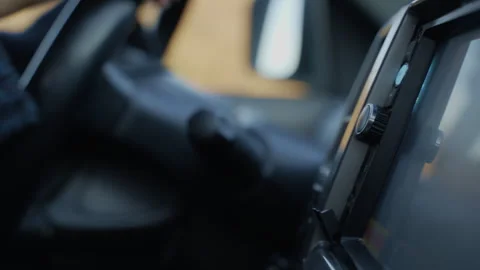 Driver's hand changing the volume of music Video stock 302211859