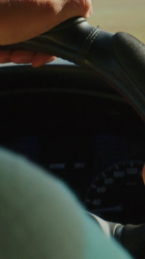 Driver's hand firmly on wheel, navigating countryside road Stock Footage 335571194