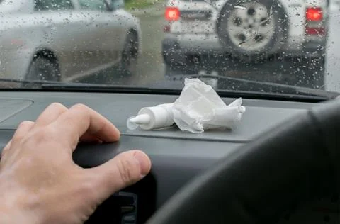 Driver's hand keeps the spray from a runny nose Stock Photos