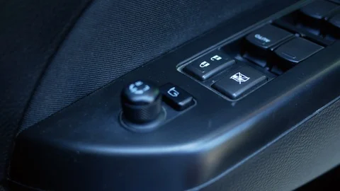  Driver's hand pressing on button switch electric lock doors in car for safety.  Vídeos de archivo 120384311