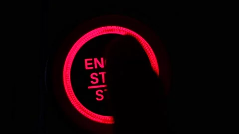 The driver's hand is pressing the car start button. Concept of transportation  Stock Footage 132615574