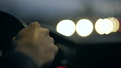The driver's hand on the steering wheel against the background of the night road Stock Footage 88554775