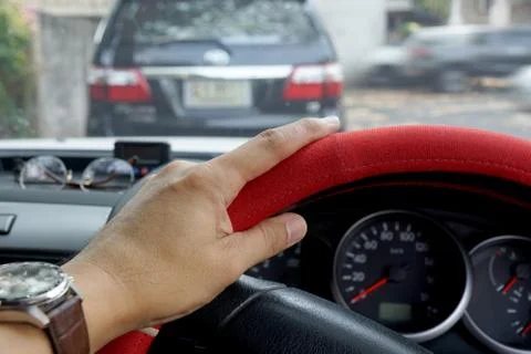 Driver's hand on the steering wheel inside of a pickup truck Stock Photos