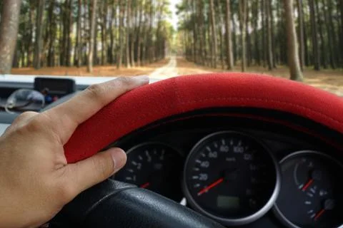 Driver's hand on the steering wheel inside of a pickup truck Stock Photos