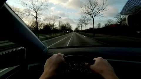Driver's hand on the steering wheel while driving a car on the countryside road. Stock-Footage 336266971