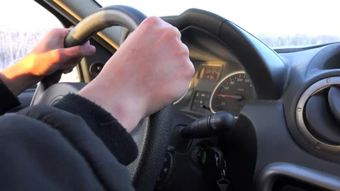 Driver's hands on the car steering wheel.  Stable 40 kmh (25 mph) Stock Footage 254607804