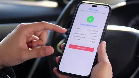 A drivers hands finalize a car leasing agreement through a mobile application Stock Footage 316387116