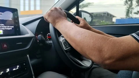Driver's Hands Steering a Car in an Urban Environment Stock Footage 305367687