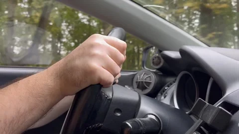 Driver's hands on the steering wheel close-up, a man driving a car Stock Footage 252021011