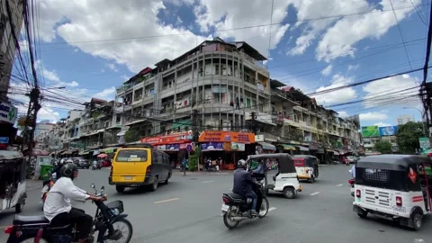 Drivers navigate through a busy junction in Phnom Penh, Cambodia 4K Stock Footage 196791901