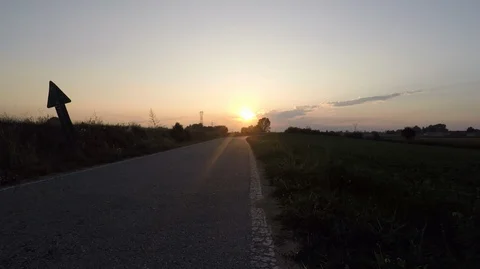 Driver's point of view that driving at sunset in the countryside is overtaken Stock Footage 118889650