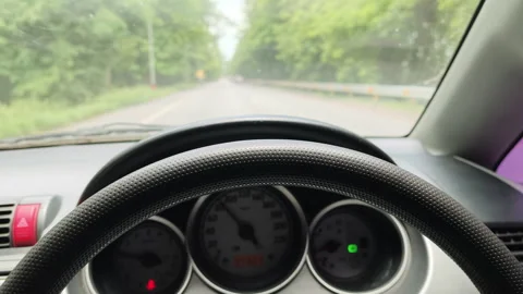A driver's point-of-view (POV) shot showcasing the steering wheel and circular  Video stock 337354622