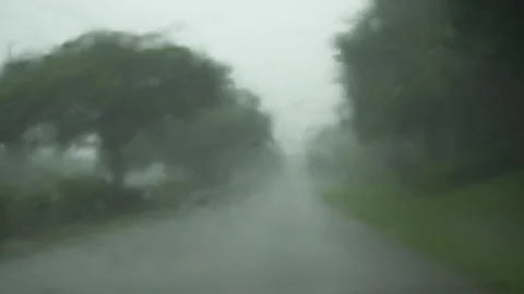 Driver's Point of View through Windshield Traveling in Rain Stock Footage 284176527