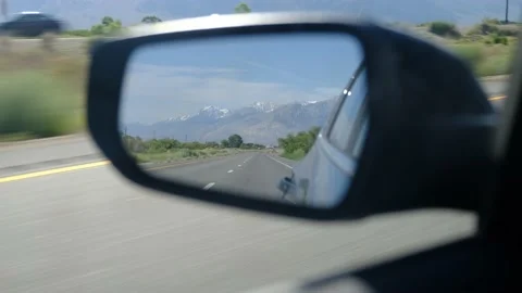 Driver's point of view in vehicle rearview mirror view view empty road Stock Footage 232158724