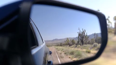 Driver's point of view in vehicle rearview mirror view view empty road Stock Footage 232163060