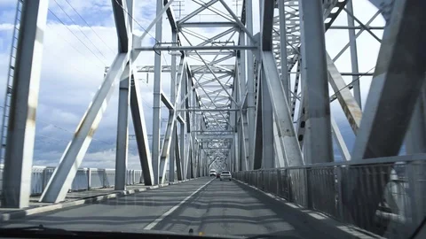 Driver's POV driving through the Bridge during a bright cloudy day. Stockbeeldmateriaal 100319836