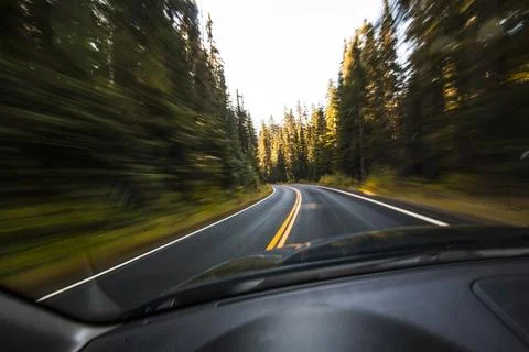 Driver's pov through windshield speeding down two lane highway, Mount Raini.. Stock Photos