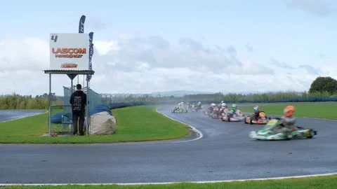 Drivers racing pro level KZ2 Go Karts on wet surface Stock Footage 133212561