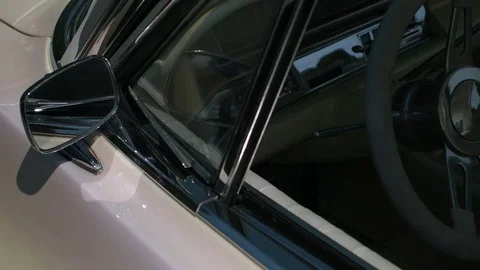 Driver’s Side Exterior to Interior Panning Shot of a Classic Car Stock Footage 79606667