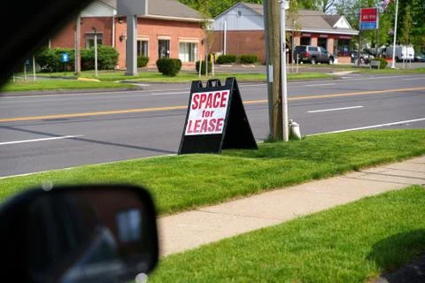A driver`s view of a folding plastic sign by the curb advertising Space For L Stock Photos