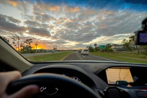 Drivers view from inside a car on a rural highway road with vehicles moving.. Stock Photos