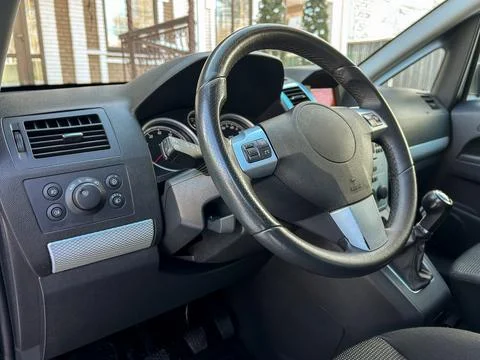 Driver's view inside a car showing steering wheel and dashboard in a parkin.. Stock Photos