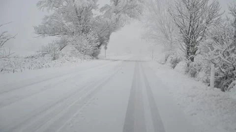 Driver's view on the road covered with a snow in winter. Stock Footage 297008400