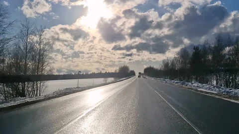 The driver's view of the road. A sunny day. By car on a forest winter road. Stock Footage 188828396