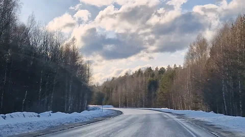 The driver's view of the road. A sunny day. By car on a forest winter road. Stock Footage 192313039