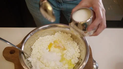 Drives a chicken egg into the curd. Curd breakfast Stock Footage 154894766