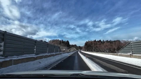 Driving across long bridge on snowy highway no traffic Video stock 333091253