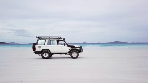 Driving along a beach on a cloudy day Stock Footage 105698904