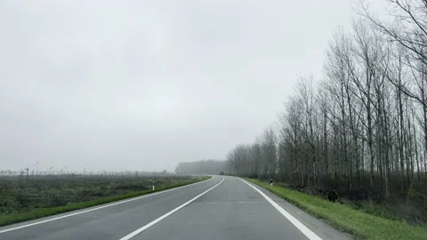 Driving along the empty road during overcast winter day 스톡 동영상 232794565