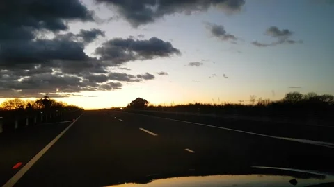 Driving along highway at sunset. Stock Footage 133155083