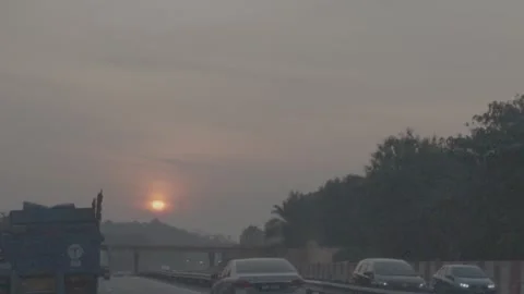 Driving along the highway at sunset, shrouded in mist. Stock Footage 344011092