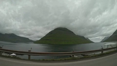 Driving along Klaksvik coast with a view of Kunoy island mountain, Faroe Islands Stock Footage 340082445