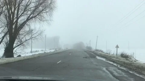 Driving along the old broken road in the fog Stock Footage 104826053