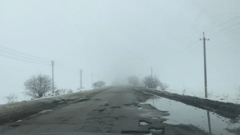 Driving along the old broken road in the fog Video stock 104826060