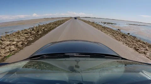 Driving along the Passage du Gois with a POV on-board camera. Video stock 330248873