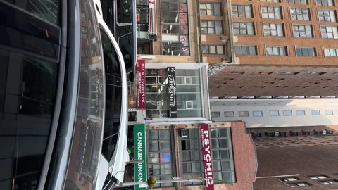 Driving along the road in Hell's Kitchen.Restaurants, shops, drug stores, trucks Stockbeeldmateriaal 242703718