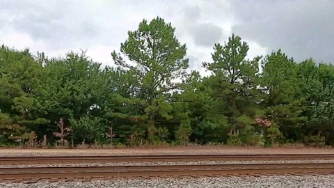 Driving along side of train tracks Stock Footage 141884398