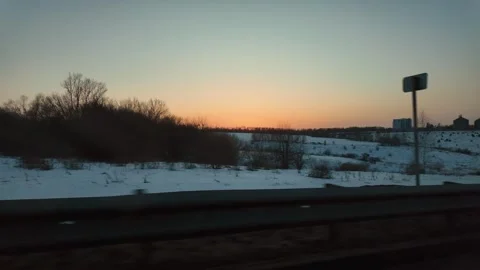 Driving along snowy landscape during winter sunset Vidéo 336184012