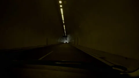Driving in and out of a tunnel going through a green hill Stock Footage 239096734